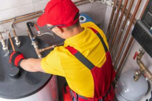 Plumber Fixing Water Heating System